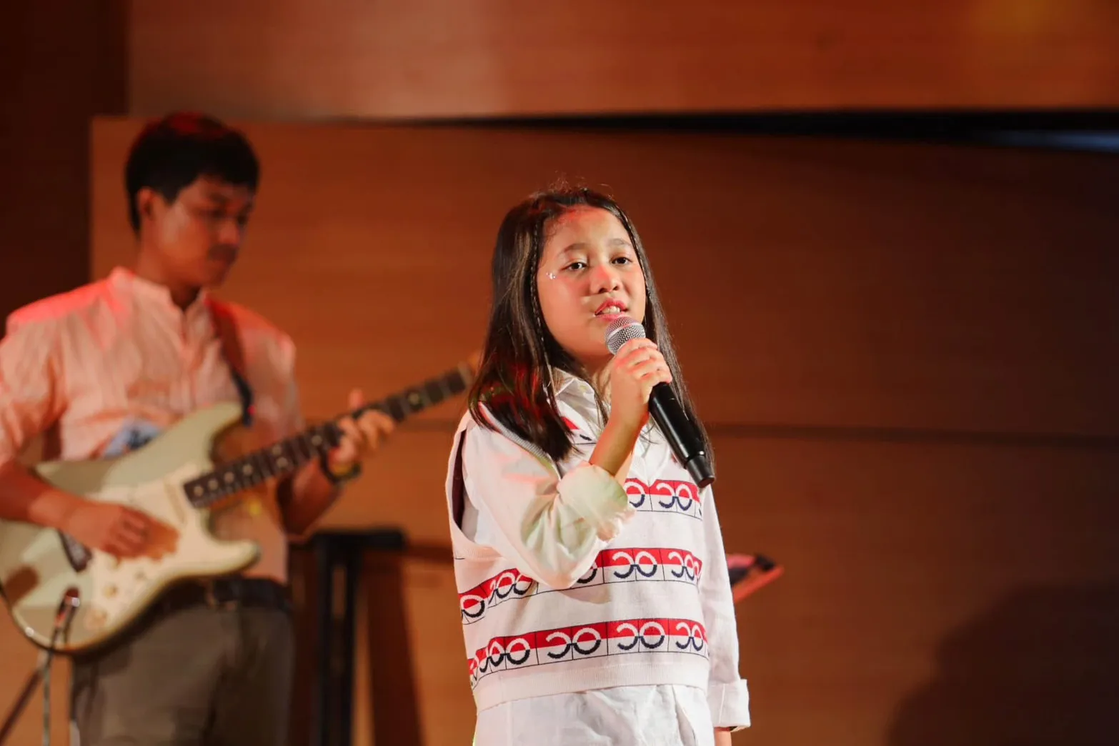นักเรียนร้องเพลงบนเวทีพร้อมวงดนตรีสด